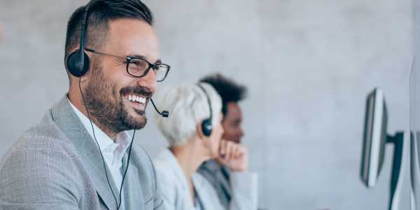 Agent on headset phone smiling